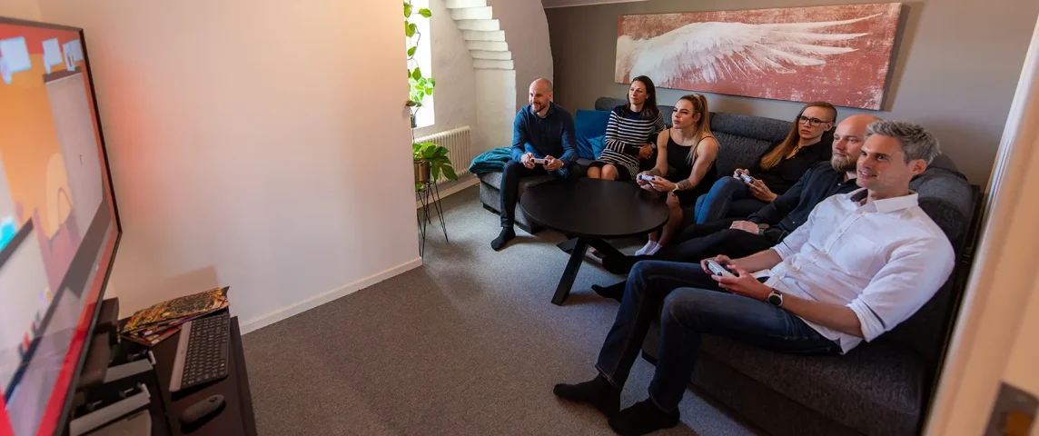 Team members seated together in the studio meeting room