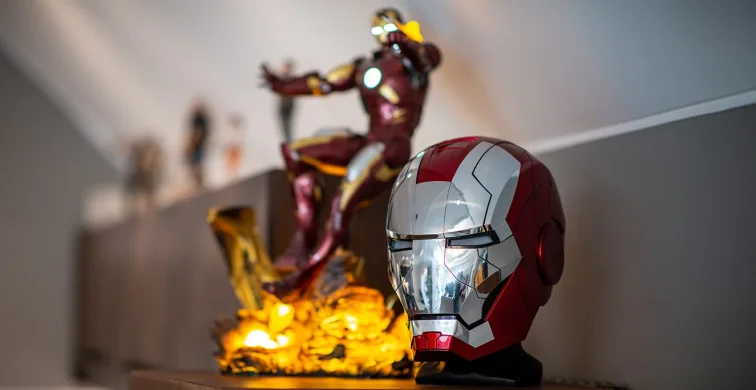 Iron Man figure and helmet displayed on a shelf in the studio