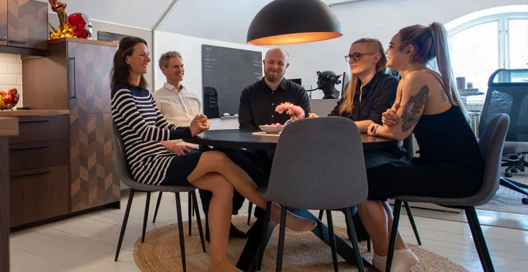 Motion Grinder team gathered around a table in the studio